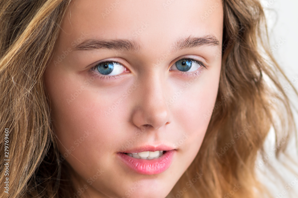 portrait of a beautiful young blonde smiling girl with long hair on a white background portrait of a beautiful young blonde smiling girl with long hair on a white background