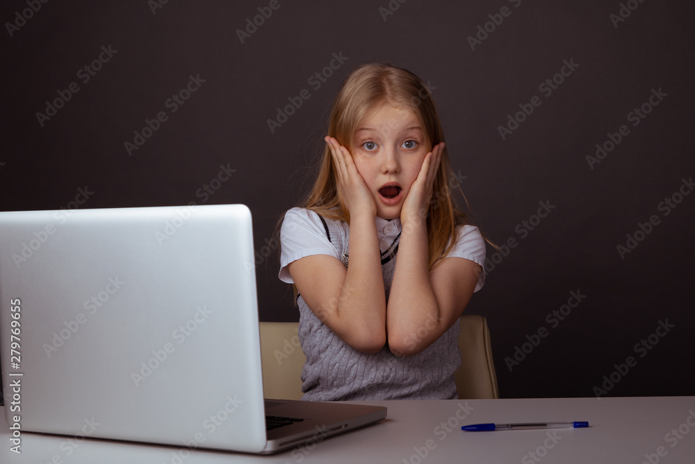 Surprised young student sitting infront of the computer in the class Surprised young student sitting infront of the computer in the class