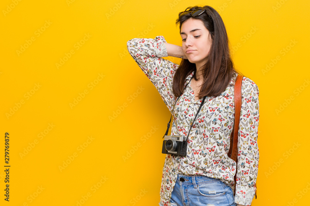 Young brunette traveler woman touching back of head, thinking and making a choice. Young brunette traveler woman touching back of head, thinking and making a choice.