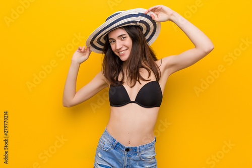 Young caucasian woman wearing a bikini and pamela