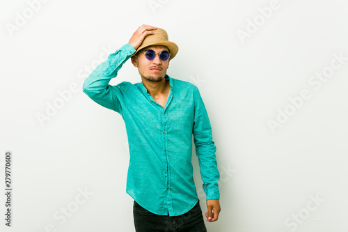 Young hispanic man wearing a summer clothes being shocked, she has remembered important meeting.