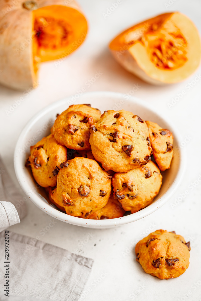 Pumpkin cookies with chocolate chips made from cake mix in a white ceramic bowl.