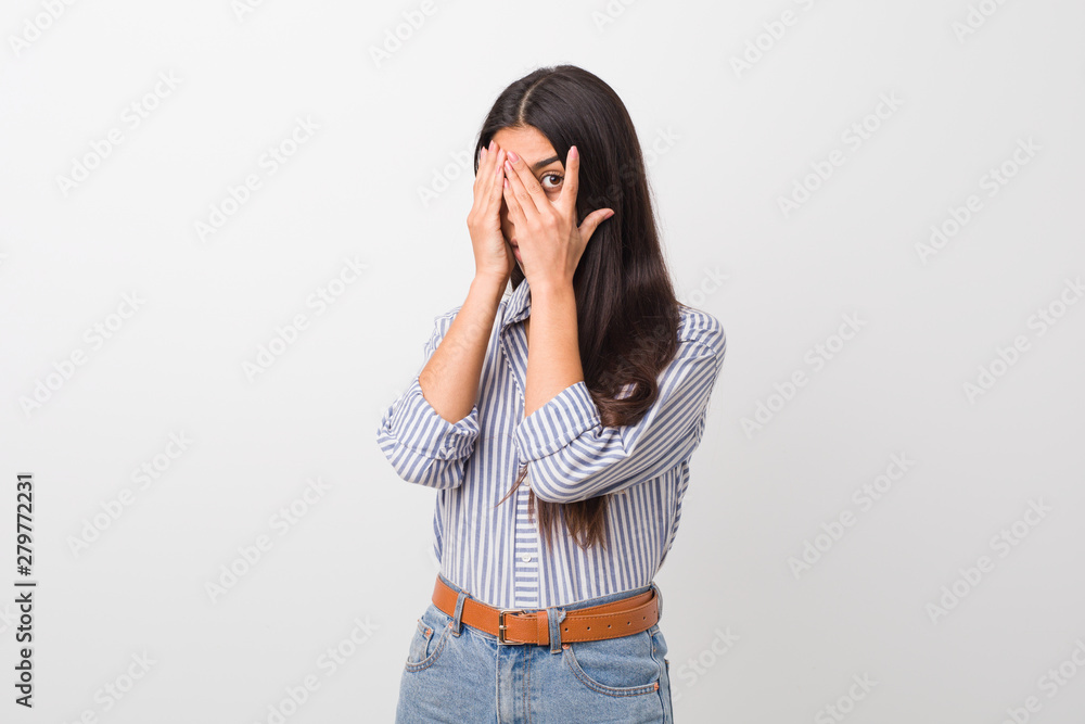 Young pretty arab woman blink through fingers frightened and nervous. Young pretty arab woman blink through fingers frightened and nervous.