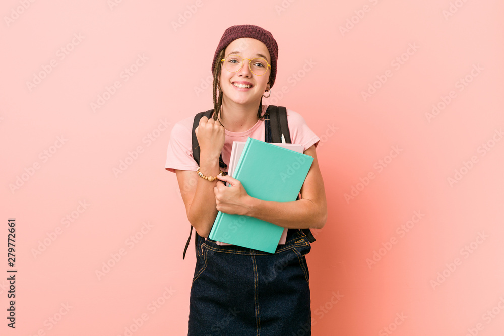 Young caucasian woman holding some notebooks cheering carefree and excited. Victory concept. Young caucasian woman holding some notebooks cheering carefree and excited. Victory concept.