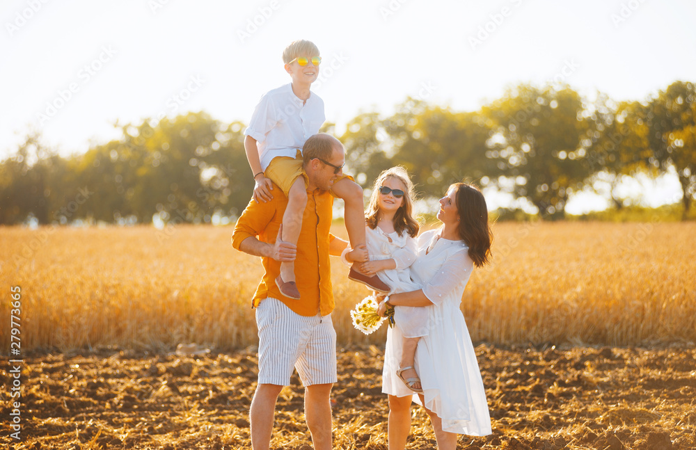 Fototapeta premium Photo of a family having fun in a field of wheat