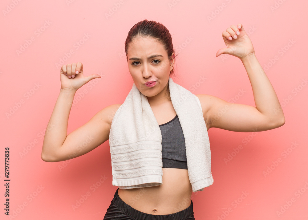 Young fitness woman pointing fingers, example to follow Young fitness woman pointing fingers, example to follow