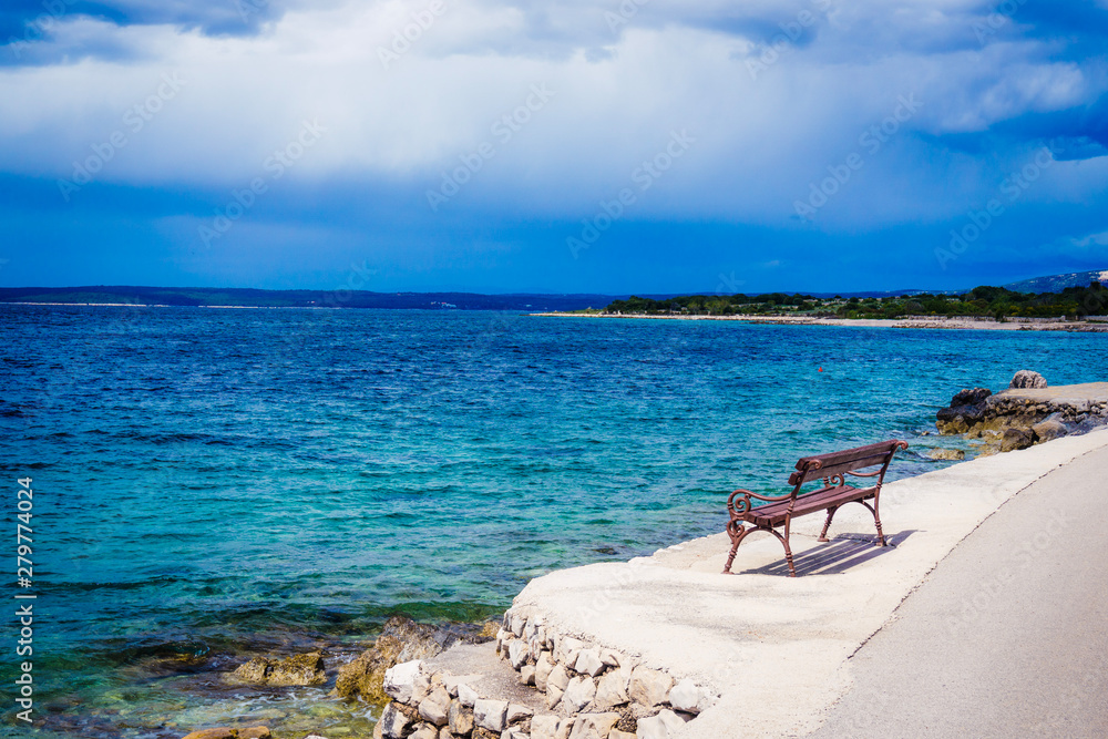 Coastal panorama with bench seen from Lun, Croatia