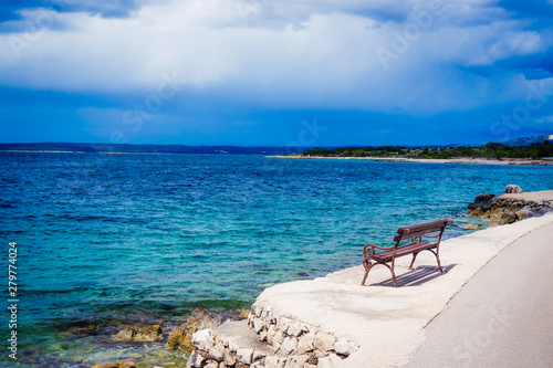 Fototapeta Naklejka Na Ścianę i Meble -  Coastal panorama with bench seen from Lun, Croatia