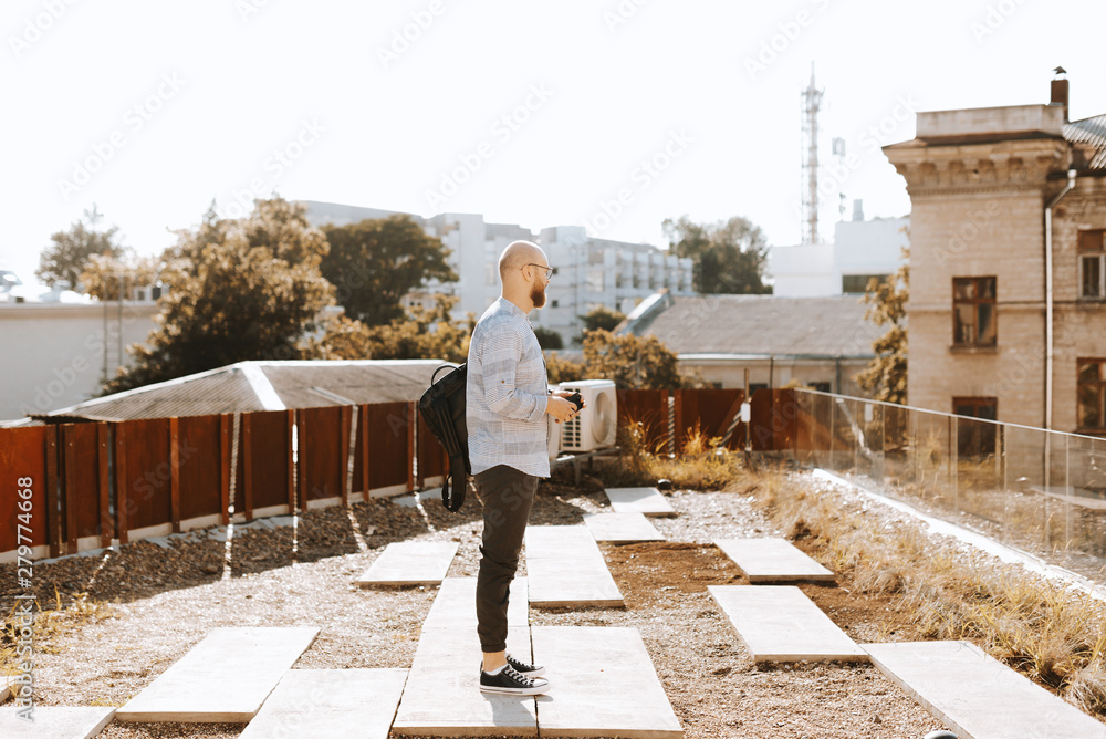 Man standing on roof and looking somewhere