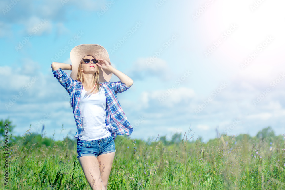 happy beautiful girl in the blooming field enjoying the sun and flowers. concept freedom and expression