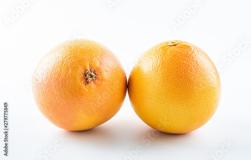 Two orange fresh grapefruits on white background