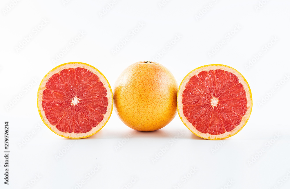 Fresh grapefruit and cut red flesh on white background Fresh grapefruit and cut red flesh on white background