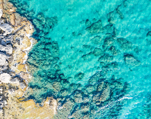 Aerial view of beautiful seashore in summer. Rocky beach and green islands seen from above.