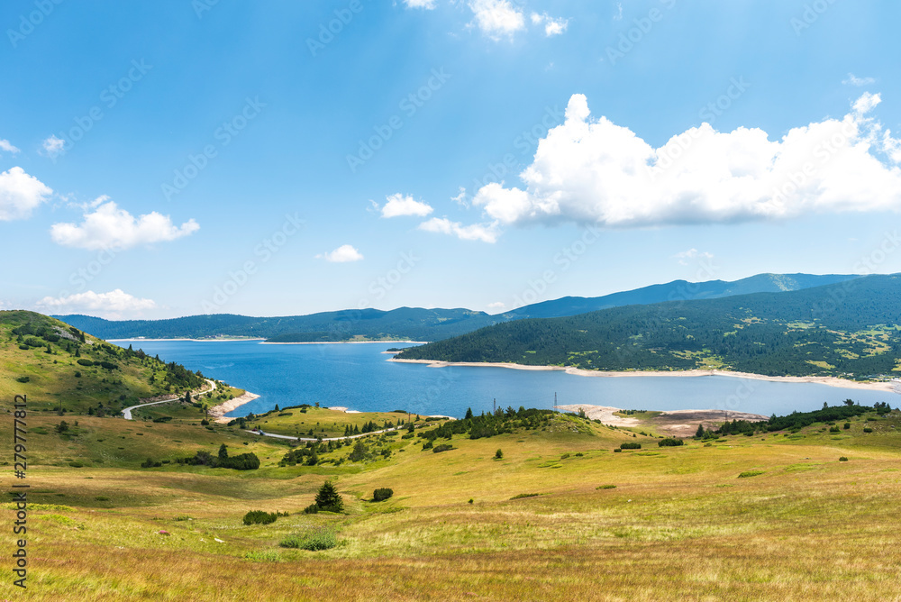 Panoramic view on mountain lake in front of mountain range Panoramic view on mountain lake in front of mountain range