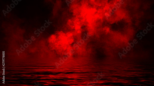 Mistery coastal fog . Red smoke on the shore . Reflection in water.