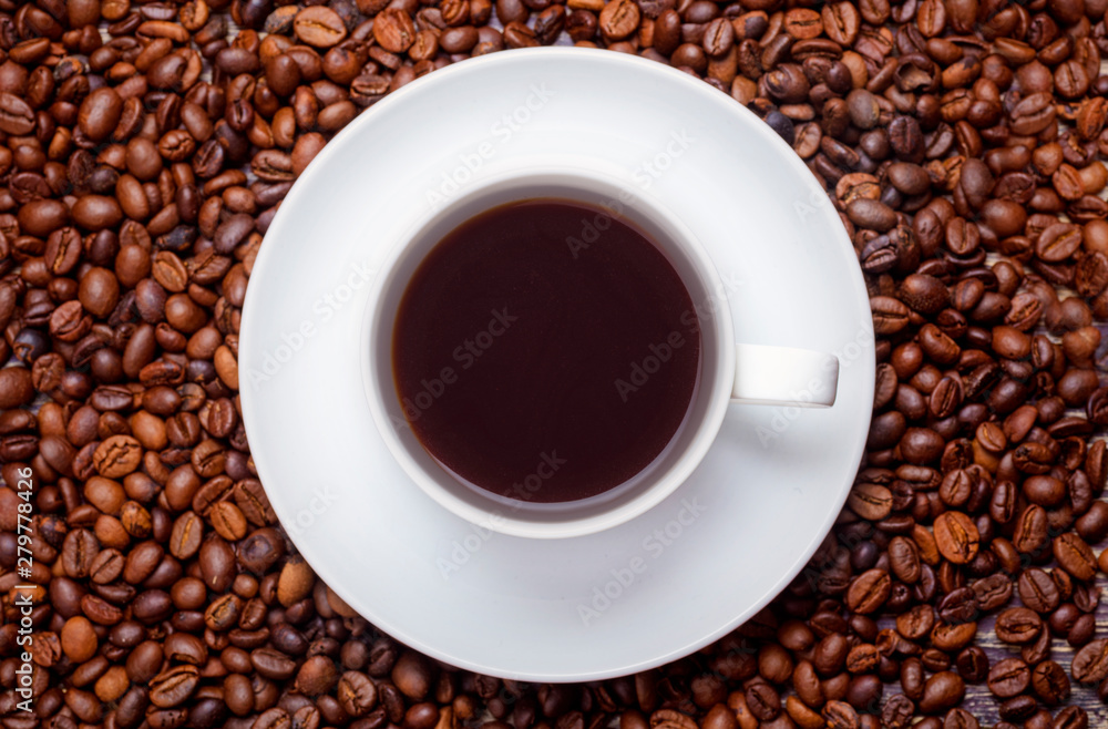 The cup of hot coffee with coffee beans The cup of hot coffee with coffee beans