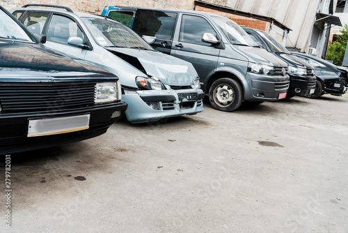 damaged vehicle after car accident near modern automobiles