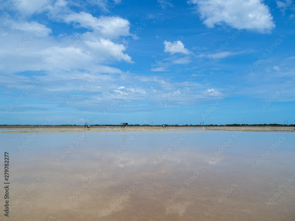 Sea salt fields local farm industry on a beautiful blue sky in Thailand, salt-pond, salt-farm Sea salt fields local farm industry on a beautiful blue sky in Thailand, salt-pond, salt-farm
