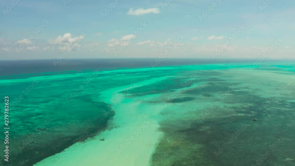 Tropical lagoons with turquoise water, coral reef against the sky with clouds, top view. Balabac, Palawan, Philippines. Summer and travel vacation concept. Tropical lagoons with turquoise water, coral reef against the sky with clouds, top view. Balabac, Palawan, Philippines. Summer and travel vacation concept.