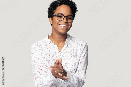 Happy biracial millennial woman laugh isolated in studio