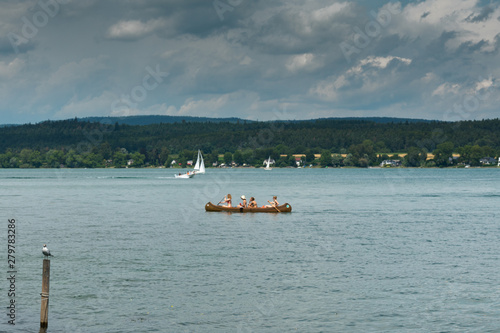 teenage female friends rowing on Lake Constance on a beautiful summer day photo