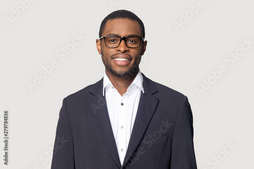 Smiling black man in suit posing on studio background