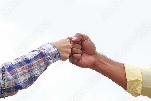Fist bump on formal wear, gesturing an agreement and cooperation