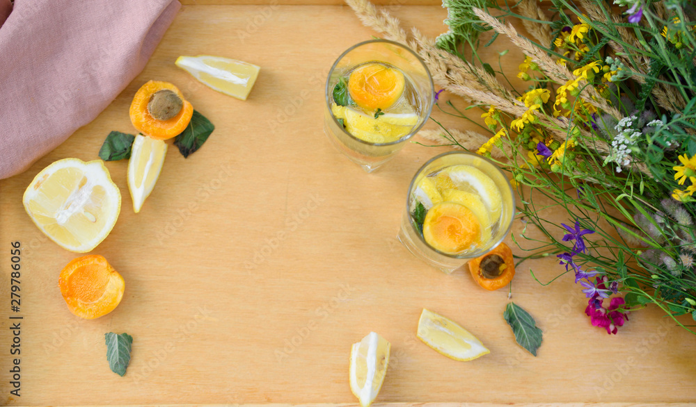 Summer lemonade with lemon, lime, ginger, with wildflowers on the table Summer lemonade with lemon, lime, ginger, with wildflowers on the table