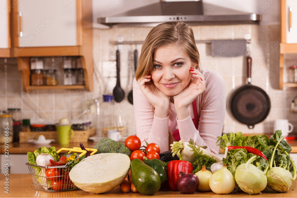 Woman having vegetables on table