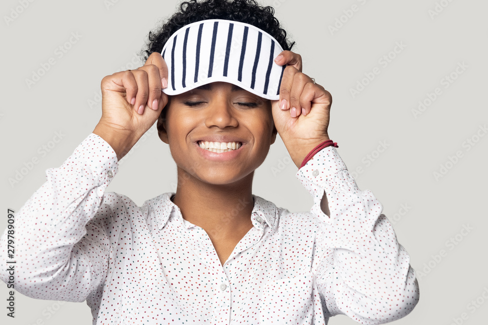 Smiling biracial girl wearing sleeping mask on head Smiling biracial girl wearing sleeping mask on head