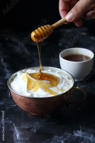 Honey and yogurt in a bowl,...