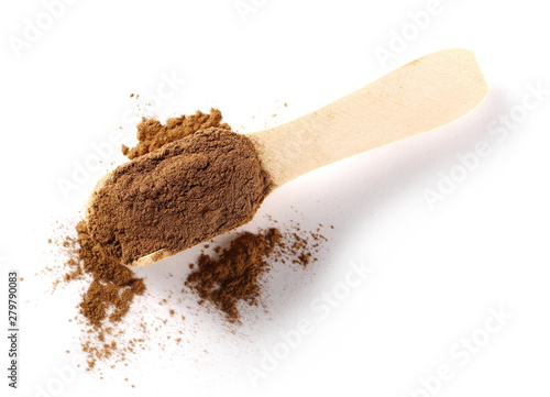 Cinnamon powder with wooden spoon isolated on white background, top view