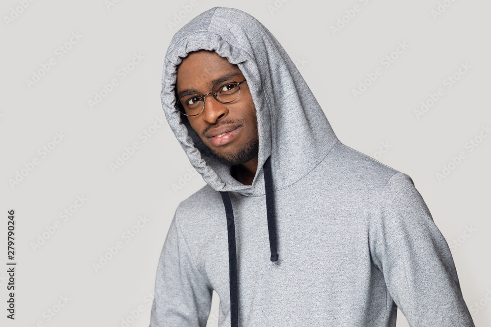 Black young guy wearing hoodie posing looking at camera Black young guy wearing hoodie posing looking at camera