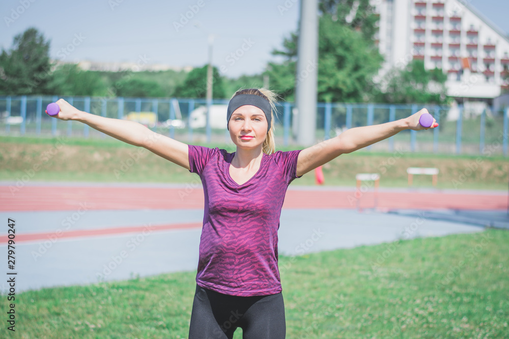 Beautiful young sportswoman doing fitness exercises Beautiful young sportswoman doing fitness exercises