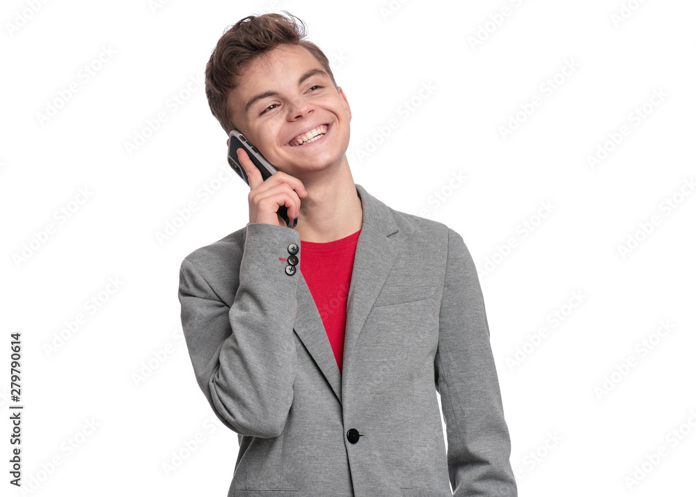 Portrait of Handsome Teen Boy talk to Mobile Phone, isolated on white background. Smiling Child standing and using Cell Phone. Cute modern Teenager in suit with Smartphone. Portrait of Handsome Teen Boy talk to Mobile Phone, isolated on white background. Smiling Child standing and using Cell Phone. Cute modern Teenager in suit with Smartphone.
