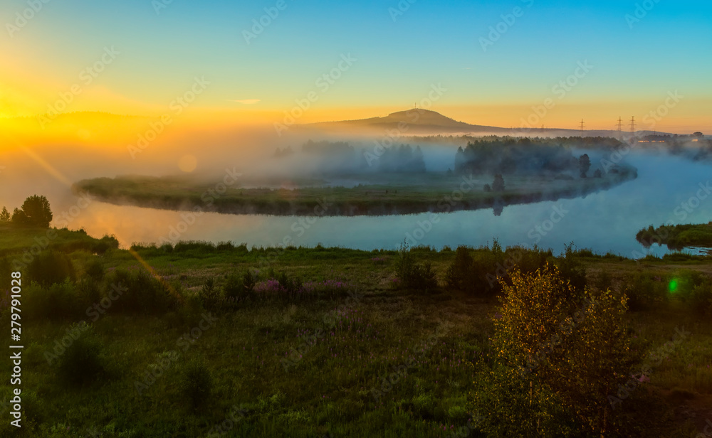 Morning foggy landscape with curved river and green hills. Summer misty Elbe river and low mountains.