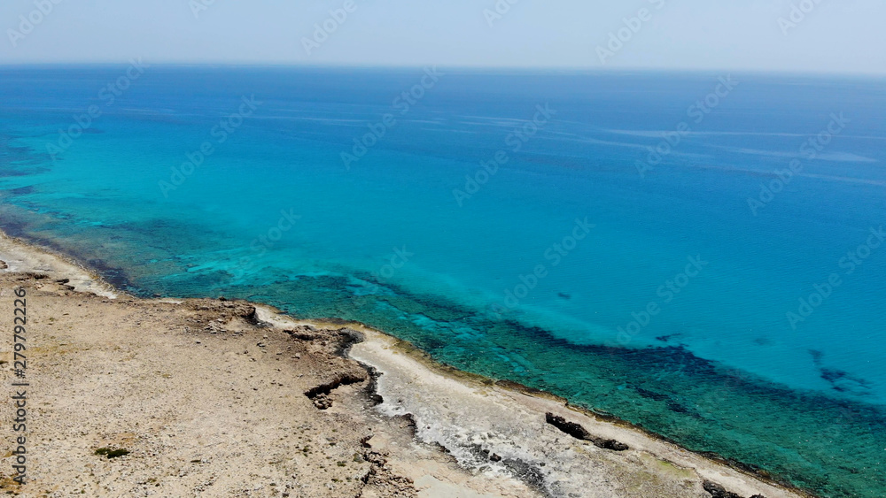 The rocky coast of Cyprus with azure water near Ayia Napa. Flying drone over the sea The rocky coast of Cyprus with azure water near Ayia Napa. Flying drone over the sea
