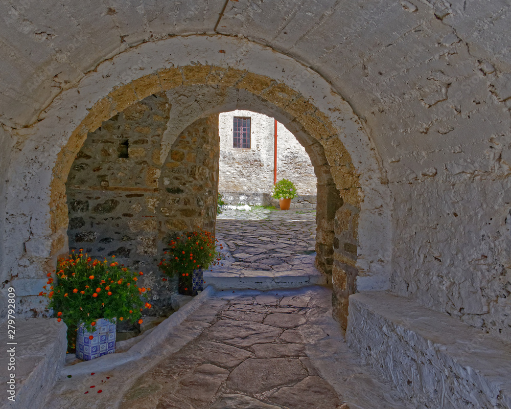 Greece, arched alley and old stone house in Crete island