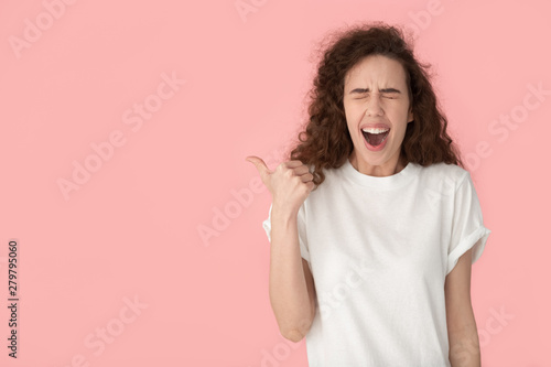 Wallpaper Mural Cheerful brown-haired woman laughing pointing finger aside at copyspace Torontodigital.ca