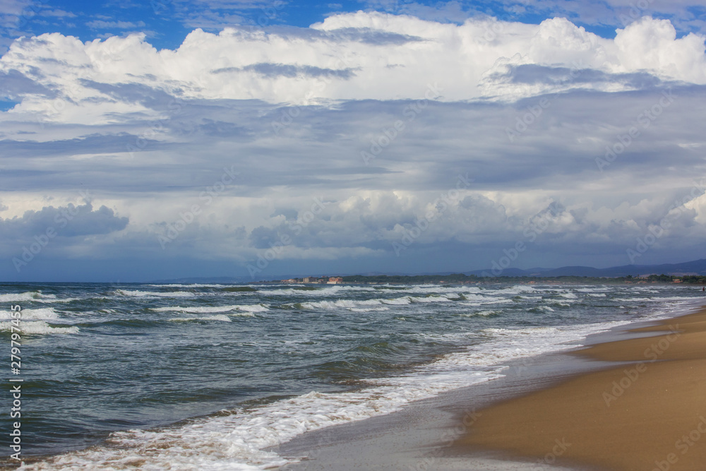 Storm sea and waves, beautiful cumulus clouds, deep blue sky Storm sea and waves, beautiful cumulus clouds, deep blue sky