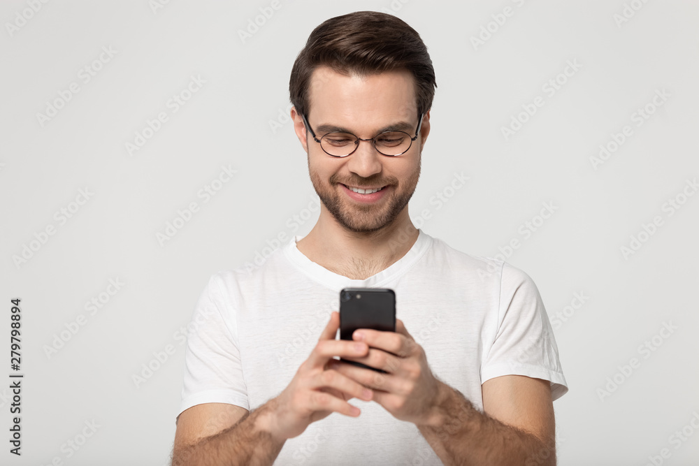 Man holding smartphone chatting with friends online studio shot Man holding smartphone chatting with friends online studio shot