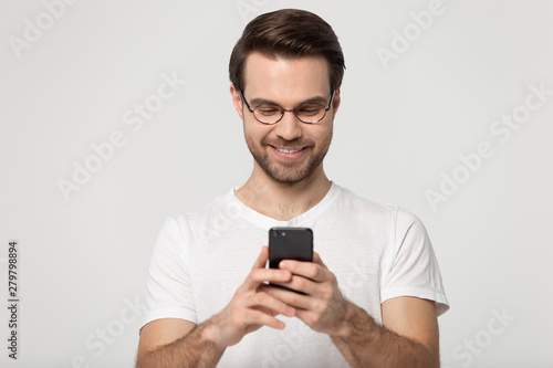 Man holding smartphone chatting with friends online studio shot © fizkes