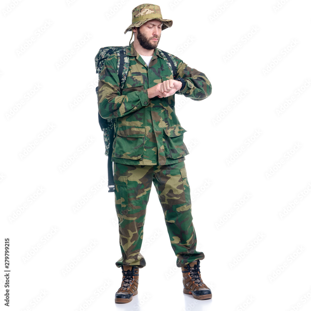 Man in camouflage clothes with backpack hiking standing looking on white background isolation Man in camouflage clothes with backpack hiking standing looking on white background isolation