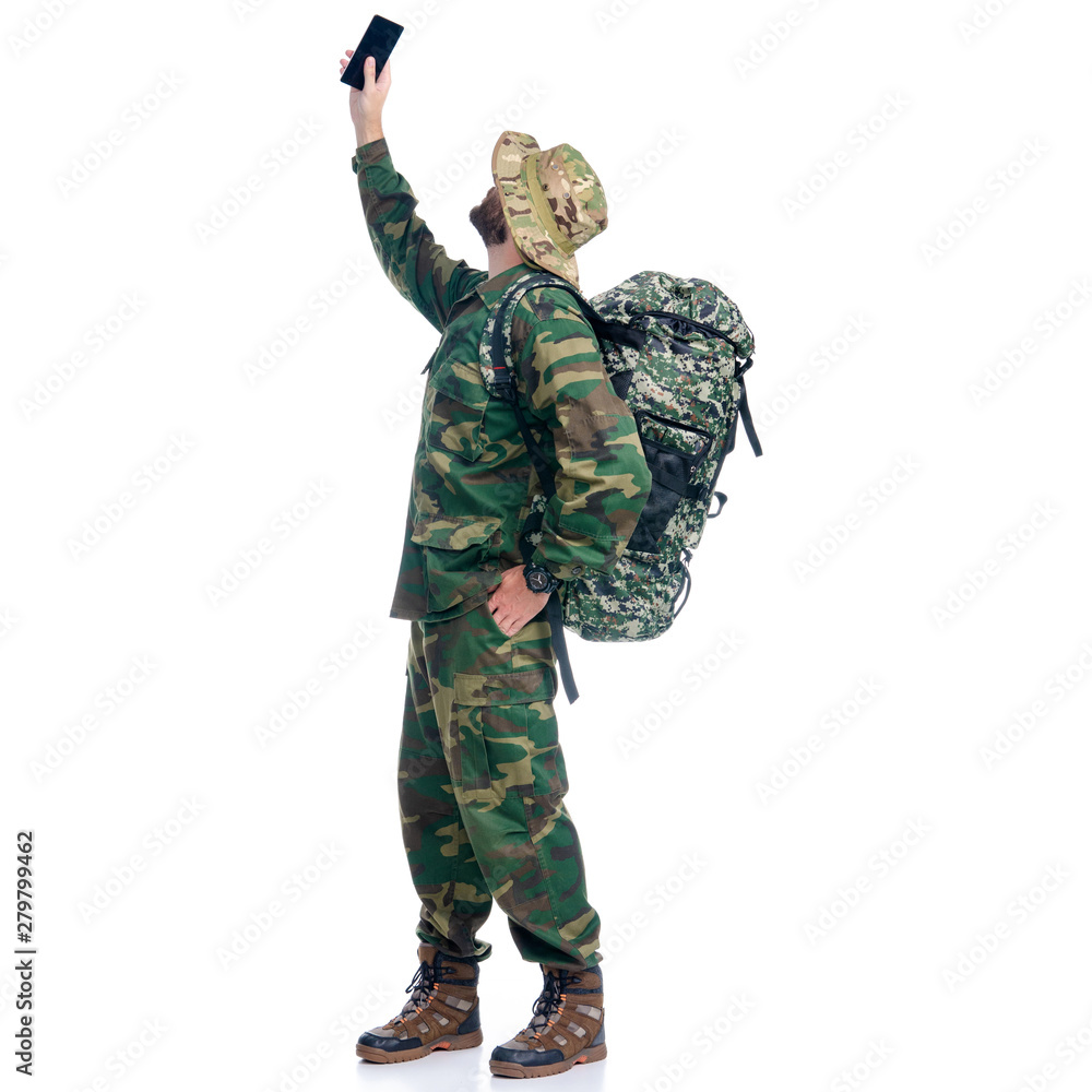 Man in camouflage clothes hiking standing catches the net on white background isolation Man in camouflage clothes hiking standing catches the net on white background isolation