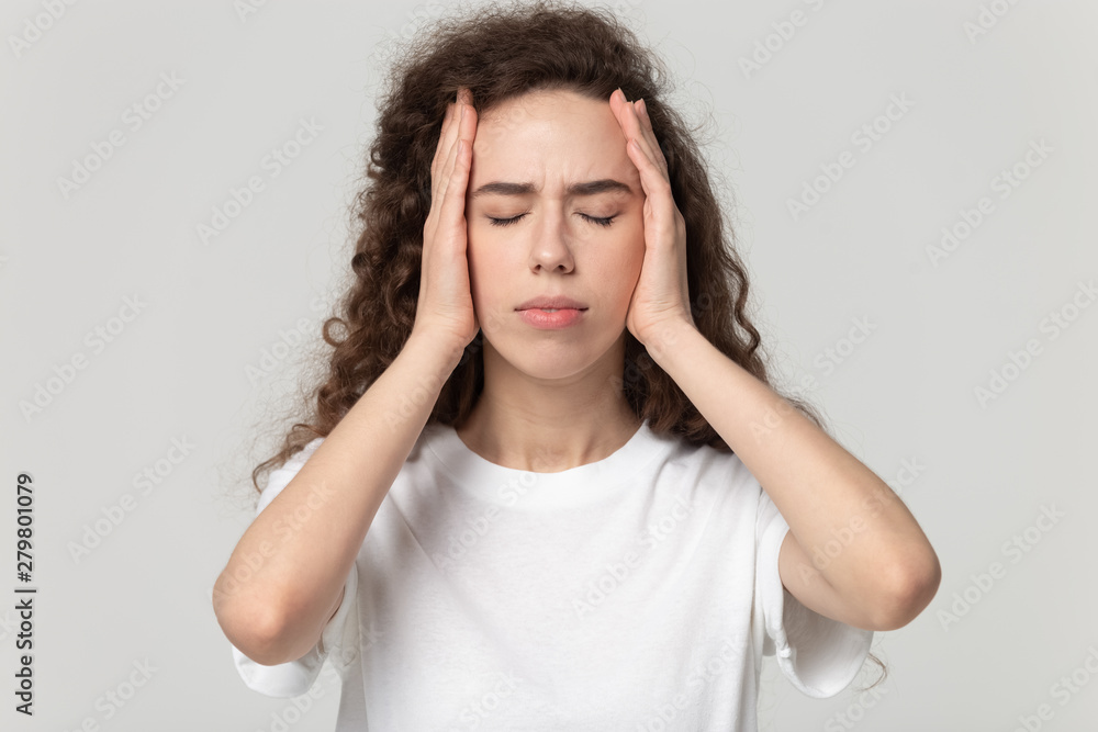 Head shot portrait stressed woman touching temples suffers from headache Head shot portrait stressed woman touching temples suffers from headache