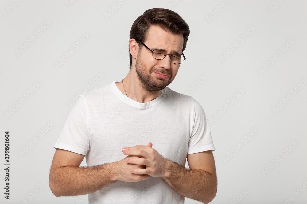 Fototapeta premium Weeper guy closed eyes whines isolated on grey studio background