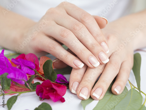 Manicured hands with colorful flowers