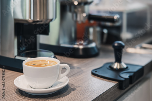 cup of coffee on the table coffee machine in a home.