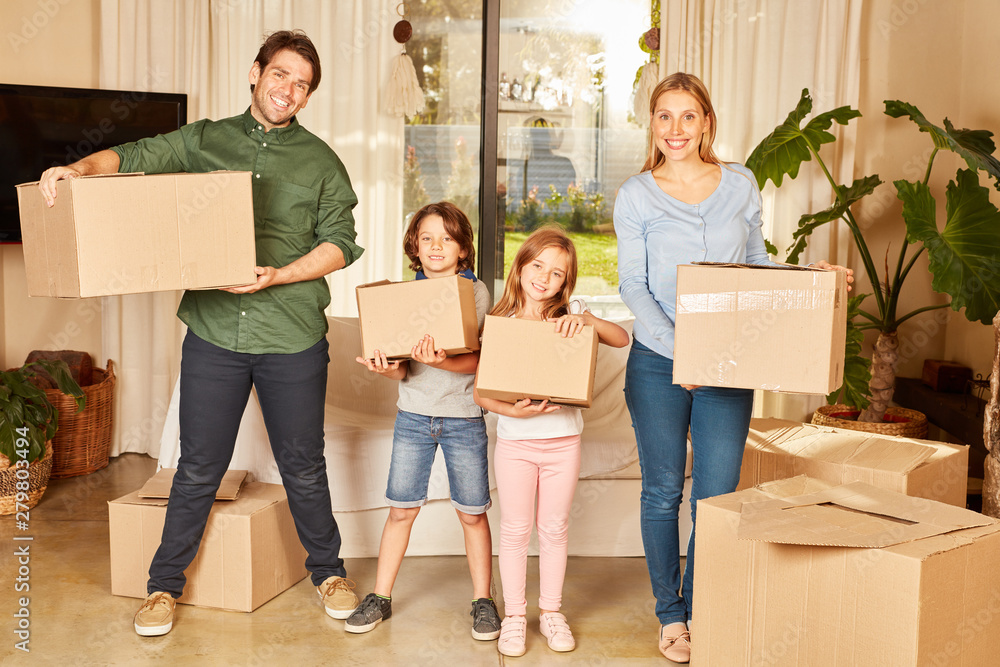 Eltern und zwei Kinder mit Umzugskartons Eltern und zwei Kinder mit Umzugskartons
