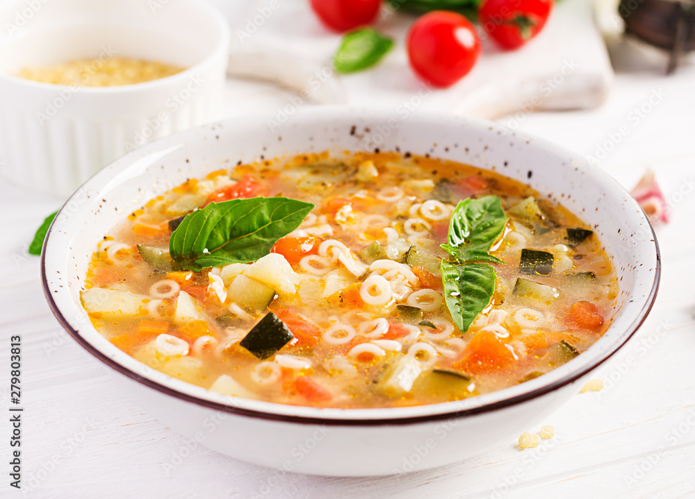 Minestrone, italian vegetable soup with pasta on white table. Vegan soup. Minestrone, italian vegetable soup with pasta on white table. Vegan soup.